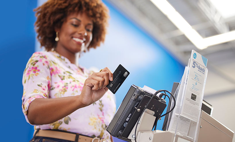 A Sam's Club member swipes their membership card at a point of sale system.